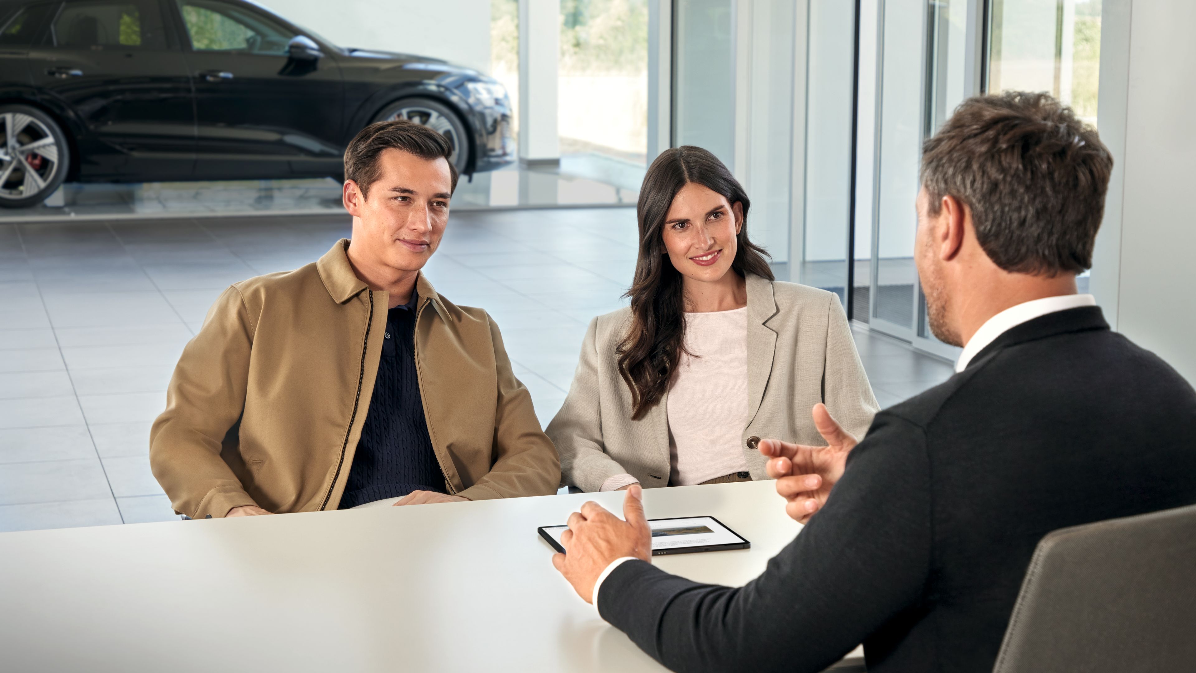 Service advisor and customers with tablet, screen with display