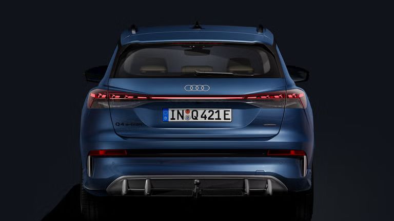 Heckansicht des Q4 SUV e-tron auf dunklem Hintergrund.